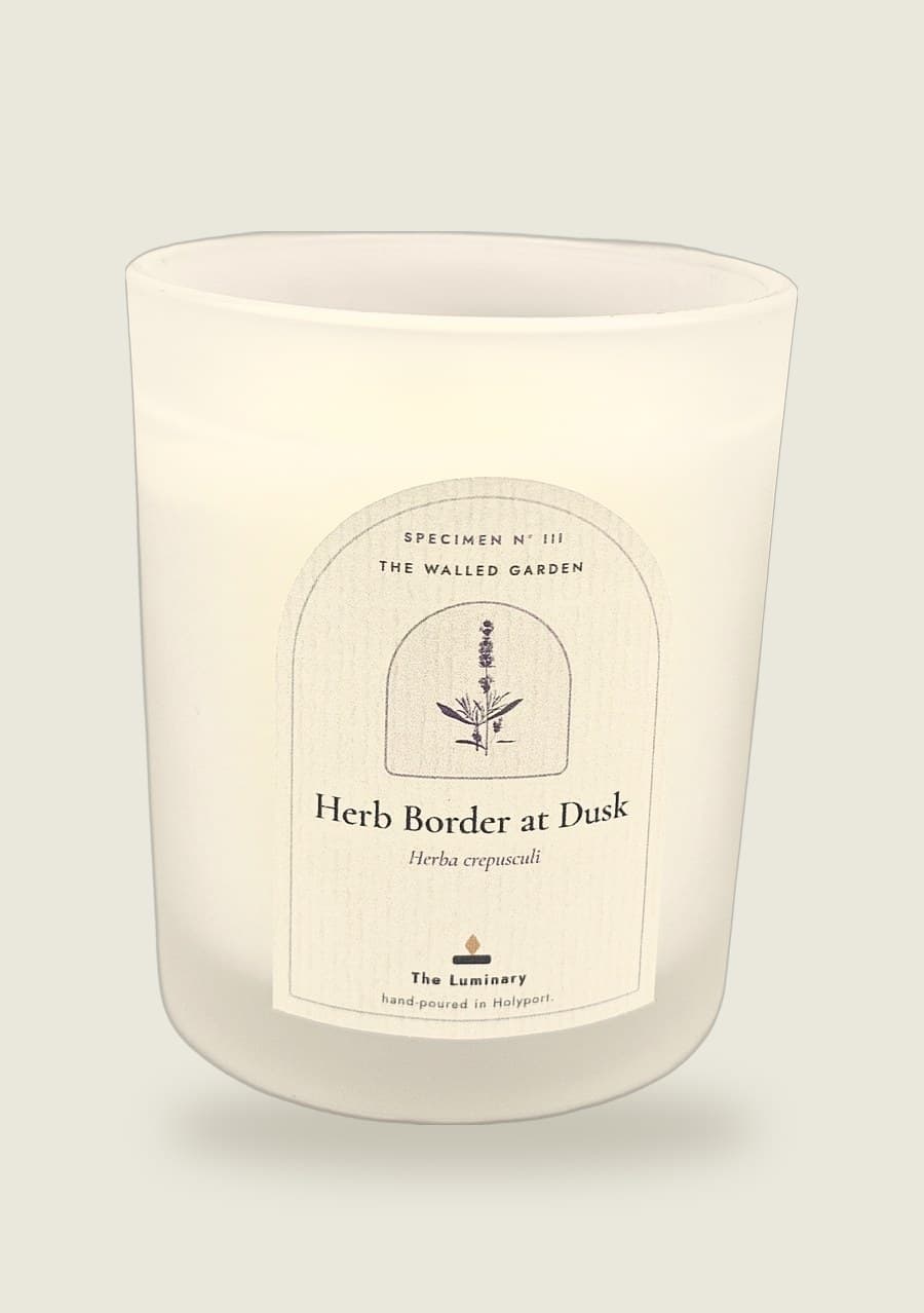 Herb Border at Dusk candle, arched specimen label on a frosted 20cl jar